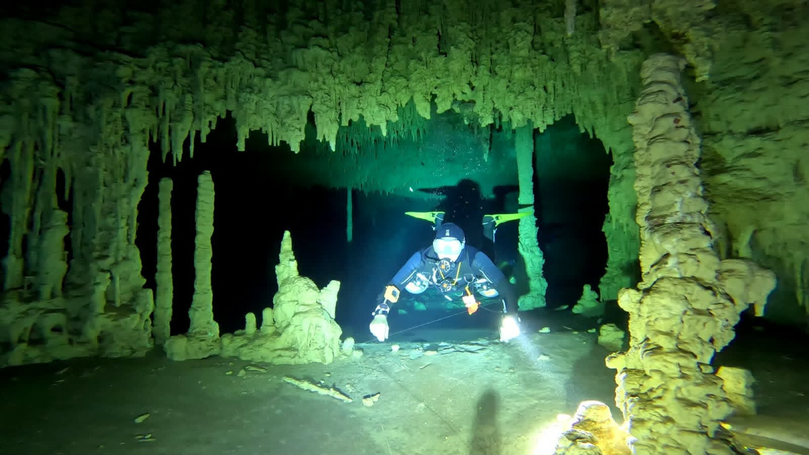 Cave diver among stalactites